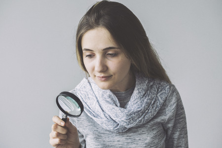 Woman with the magnifying glassの写真素材
