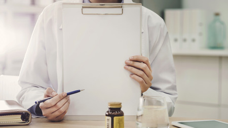 The doctor showing empty pageの写真素材