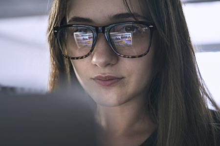 Young woman looking at computer screenの写真素材