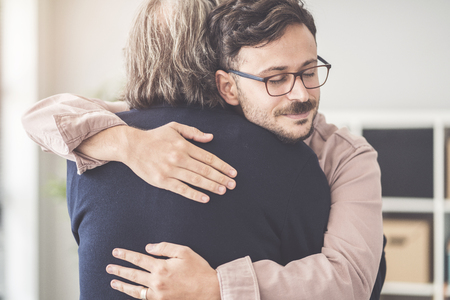 Son hugs his own fatherの写真素材