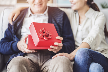 Young daughter gives her father a gift