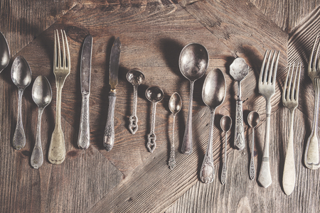 Vintage antique silverware on wooden backgroundの写真素材