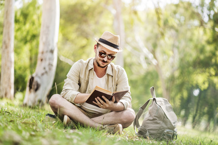 Reading a book at parkの写真素材