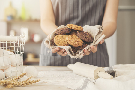 Female chef cooking delicious cookiesの写真素材