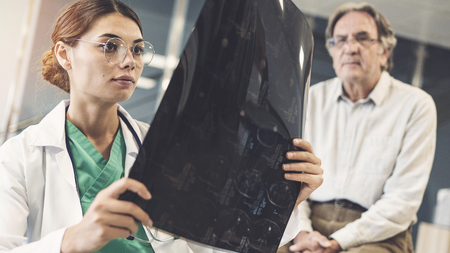 Health worker looking at x-rayの写真素材
