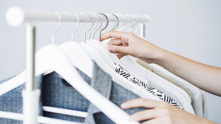 Woman choosing clothes on a rack