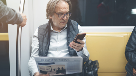 Man using mobile phone in the metro trainの写真素材