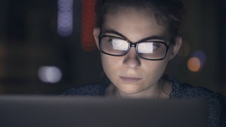 Working on computer at nightの写真素材