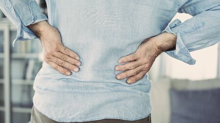 Old man with back painの写真素材