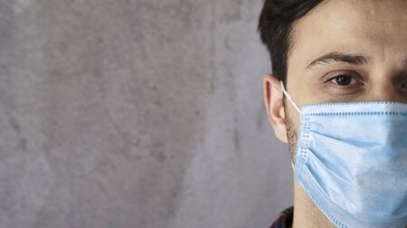 Young man wearing medical maskの写真素材