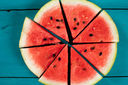 Watermelon slices on wooden backgroundの写真素材