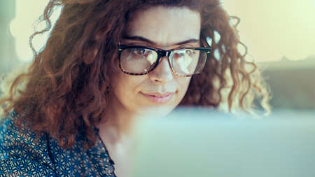 Woman working with laptop computerの写真素材