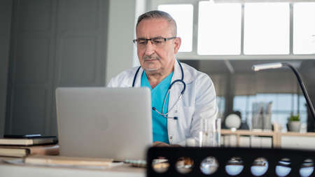 Doctor using laptop computer in the medical clinicの写真素材