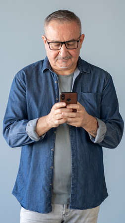 Man typing on mobile smartphoneの写真素材