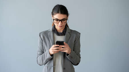 Woman typing on mobile smartphoneの写真素材