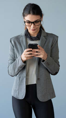 Woman typing on mobile smartphoneの写真素材