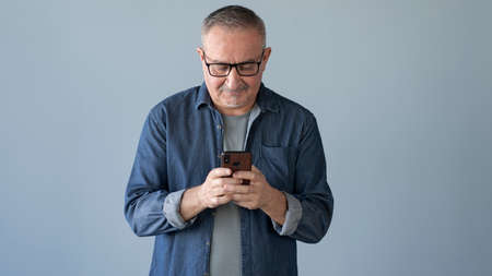 Man typing on mobile smartphoneの写真素材