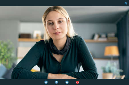Young woman smiling, listening and looking to webcam