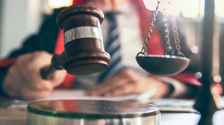 Judge holding the gavel in courtroomの写真素材