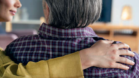 Comforting hand on shoulder of manの写真素材