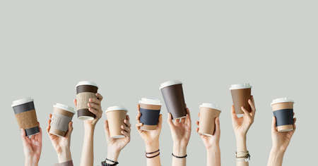 Many different arms raised up holding coffee cup