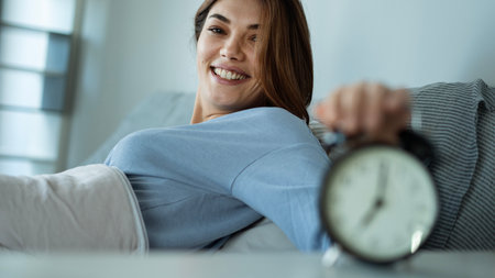 Woman smiling in the bed after waking up