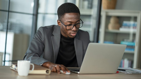 Young man using computer in officeの写真素材