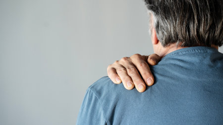 Rear view shot of a man suffering from a shoulder pain