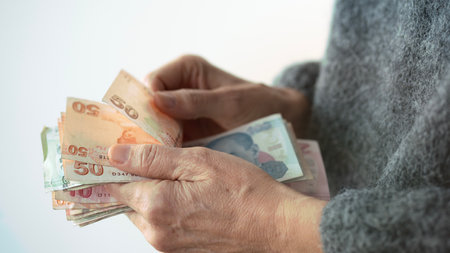 Hands holding and counting Turkish money