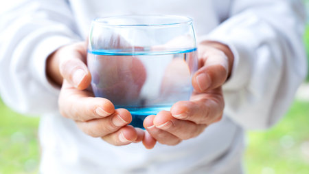 Woman hand holding a glass of waterの写真素材