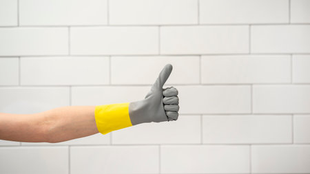 Hand in protective glove showing ok signの写真素材
