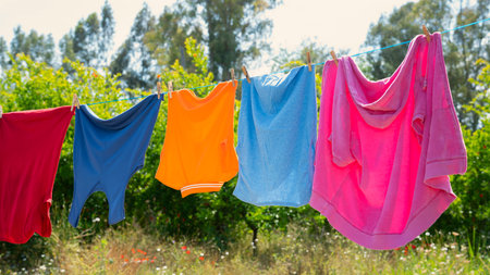 Clothes hanging to dry on a laundry lineの写真素材