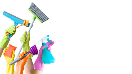Hands holding various cleaning objects