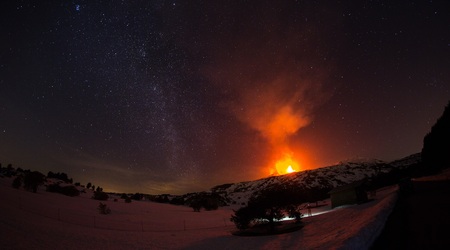Scenic eruption of the Etna Volcano and the Milky Wayの写真素材