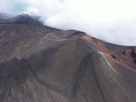Etna volcano crater with hiker and tourist from above working-aerial panoramic overviewの写真素材