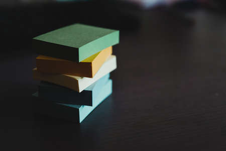 Blocks of colored stickers stacked up to form a column. The colors are blue, green, yellow and...