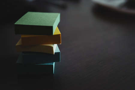Blocks of colored stickers stacked up to form a column. The colors are blue, green, yellow and...