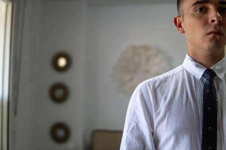 View of half a young businessman's body. He is wearing a shirt and tie.の写真素材