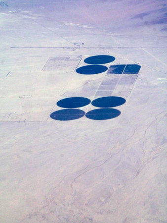Expanding farming efforts in the southwest USA's deserts by tapping deep aquifers. These seven fields sit at the foothills of an Arizona mountain range, and seem to be spaced in such a way that will allow for more circle fields.の写真素材
