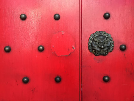 Fu dog, not lion - one broken, one missing from these temple gates in Shenzhen.の写真素材