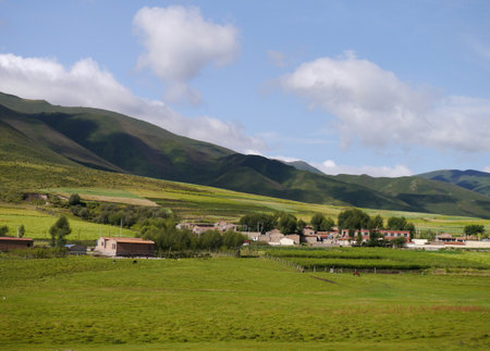 Bucolic scenery of farms and houses surround the base of Qilian Mountain.の写真素材
