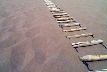 Eventually, the view at the top of the singing sand dunes is worth every step up this treacherous ladder.の写真素材
