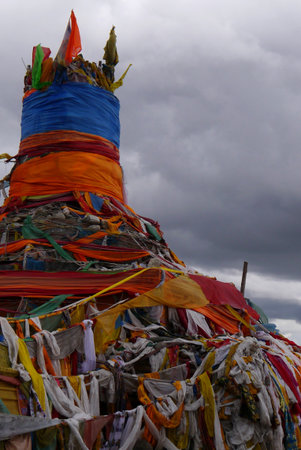 Countless layers of prayer flags, or "sutras", built this temple.. Worshippers came and threw money into the air.のeditorial素材
