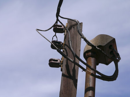 Top of a vintage utility pole with insulators and transformer box. Industrial and rather DIY. 2013の写真素材