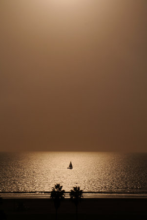 A strangely calm and empty Pacific Ocean hosted a solitary sailor this November day, 2013. Redondo Beach, California.の写真素材