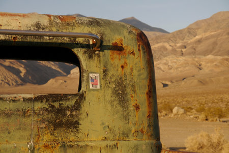 No branding in sight, just a detail of an old pickup truck left in death valley for decades. a Sept 11 memorial sticker is the only evidence of a recent interaction.のeditorial素材