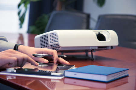 Businessman with projector. High resolution. 3D renderの写真素材