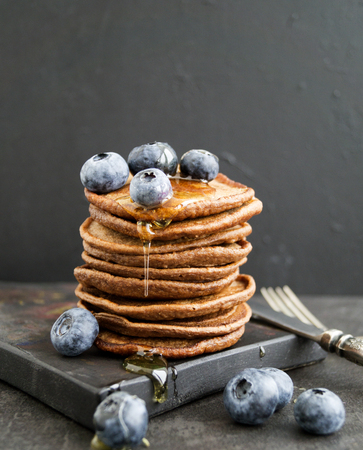 Chocolate pancakes with blueberries on a dark background.の写真素材