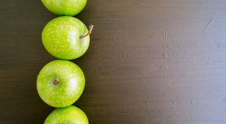 Fresh green apples on the table, close up.の写真素材