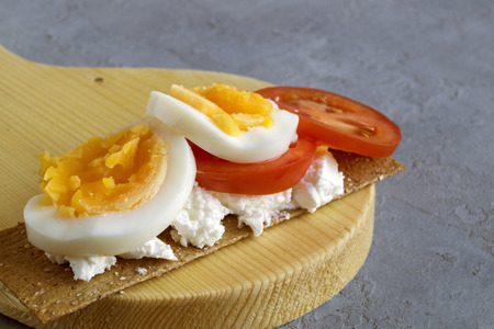 Breakfast, crispbreads with cheese, tomatoes and egg.の写真素材